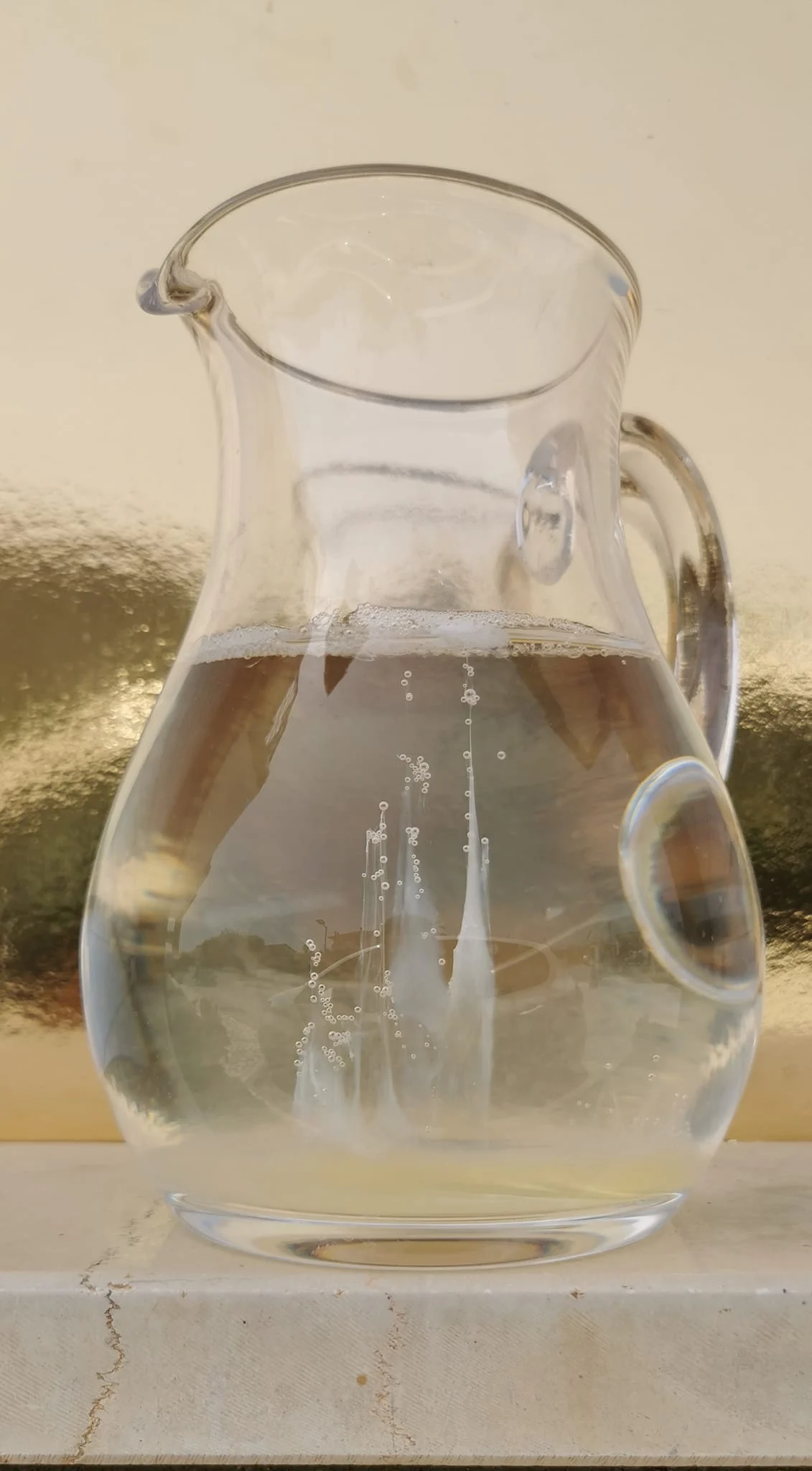 Egg white inside a pitcher of water creates the shape of a boat with sails