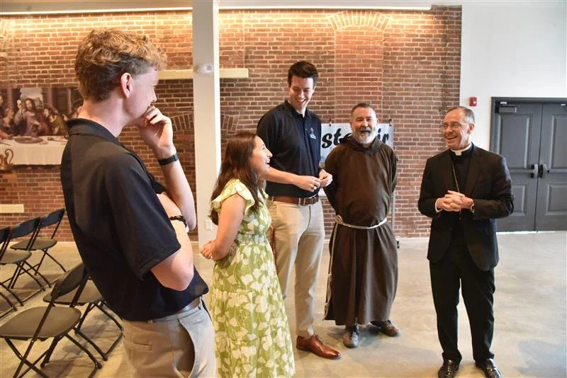 Archbishop Charles Coleman Thompson of Indianapolis and Father Christopher Iwancio with three of the perpetual pilgrims