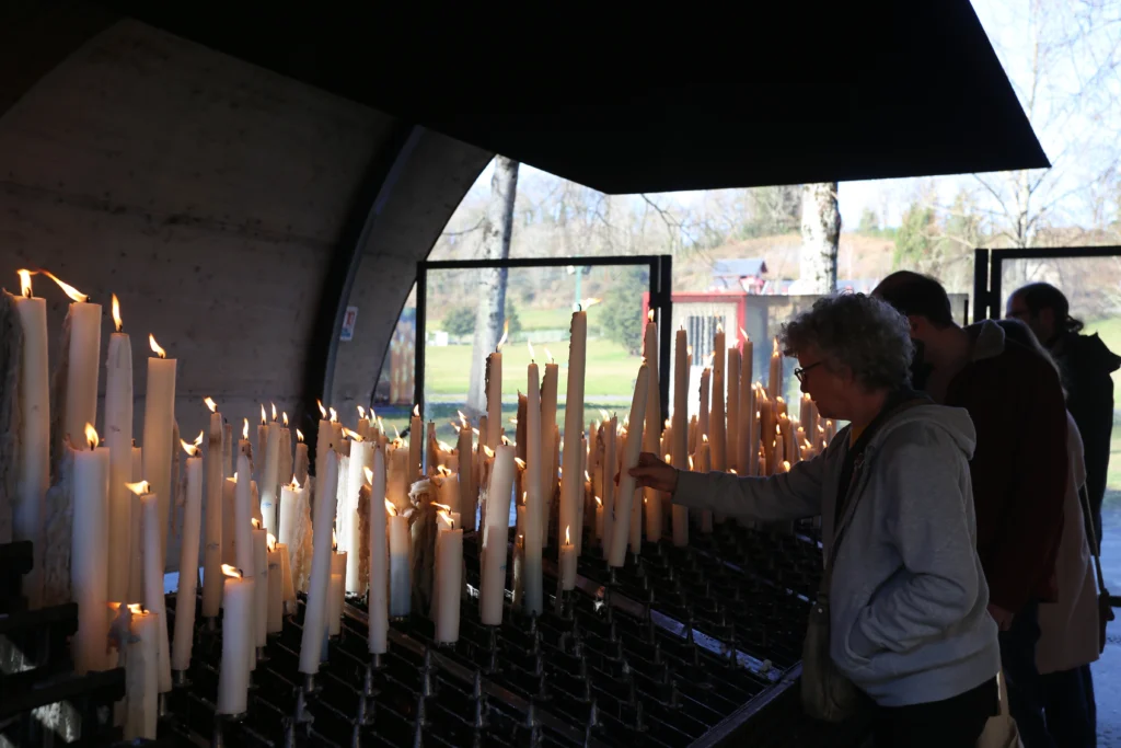 Lighting candles at Lourdes