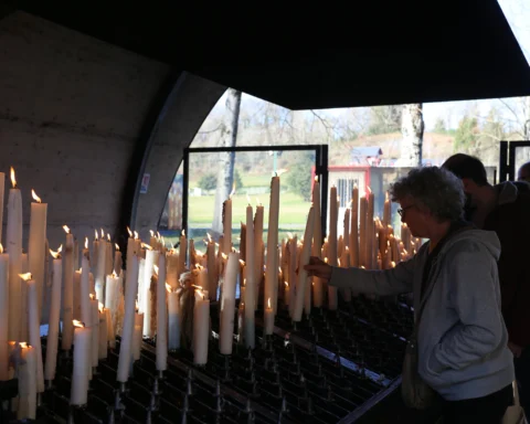 Lighting candles at Lourdes