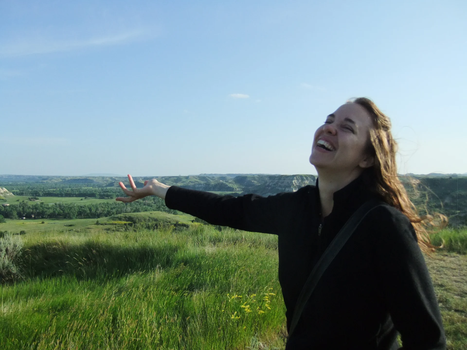 Michelle Duppong stands in front of a field of grass